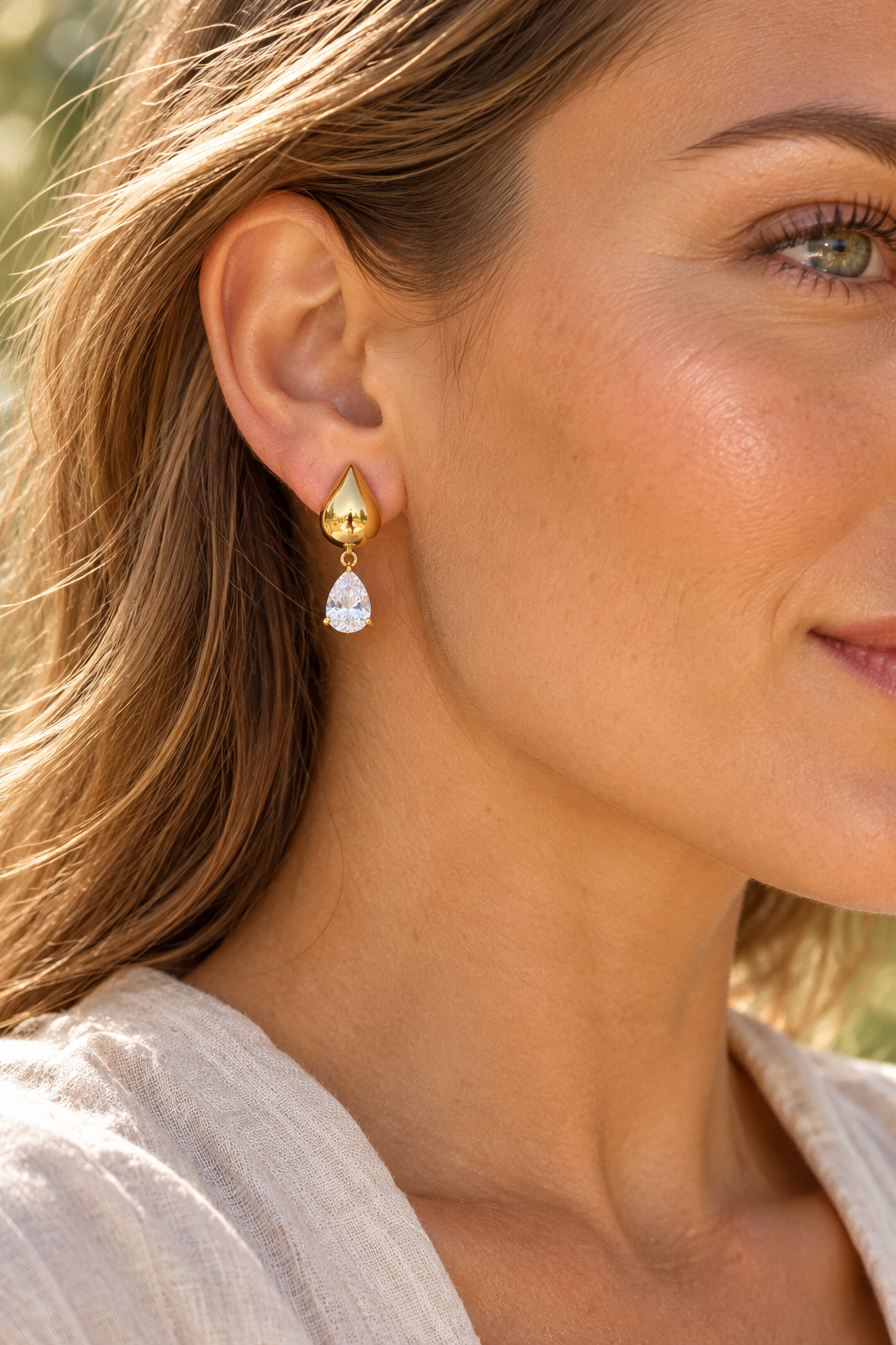 Gold Polished Teardrop Crystal Drop Earrings worn on a model