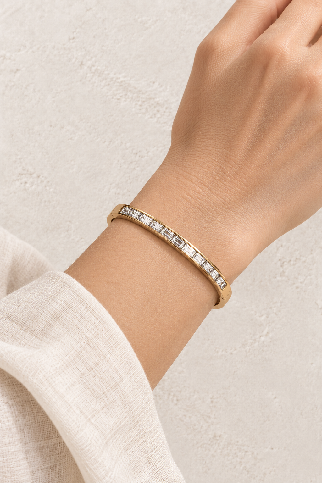 Model wearing Vela Gold Baguette Crystal Bangle