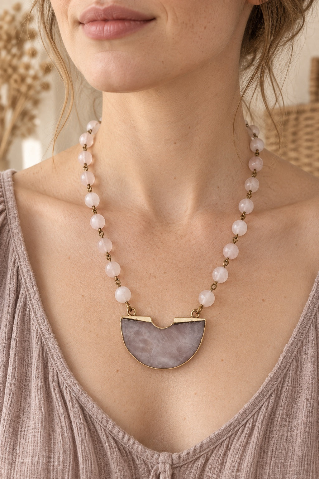 Boho model wearing the Velmira Rose Quartz half-moon statement necklace
