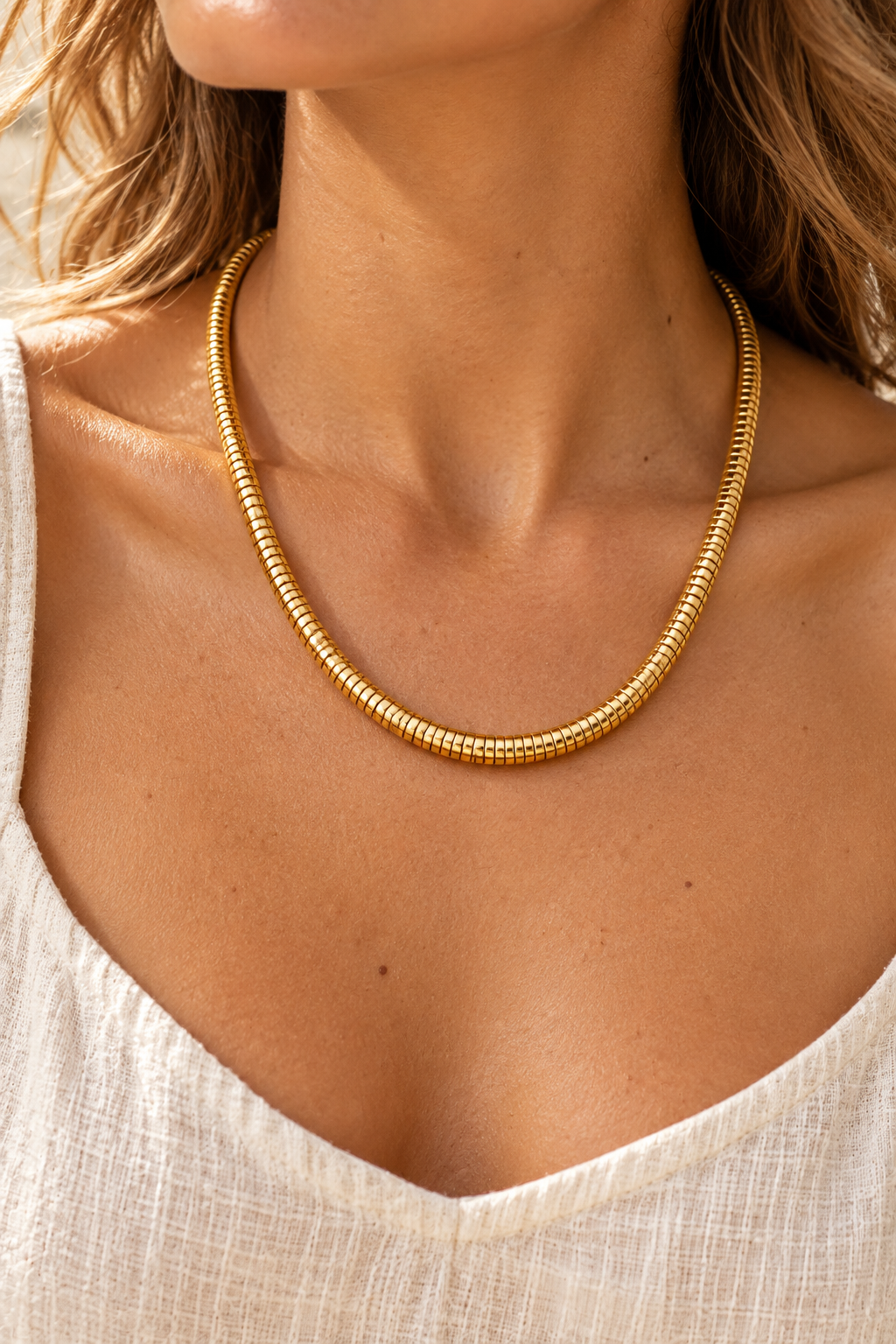 Zara Gold Snake Chain Necklace worn on a model, close-up of the gold segmented chain